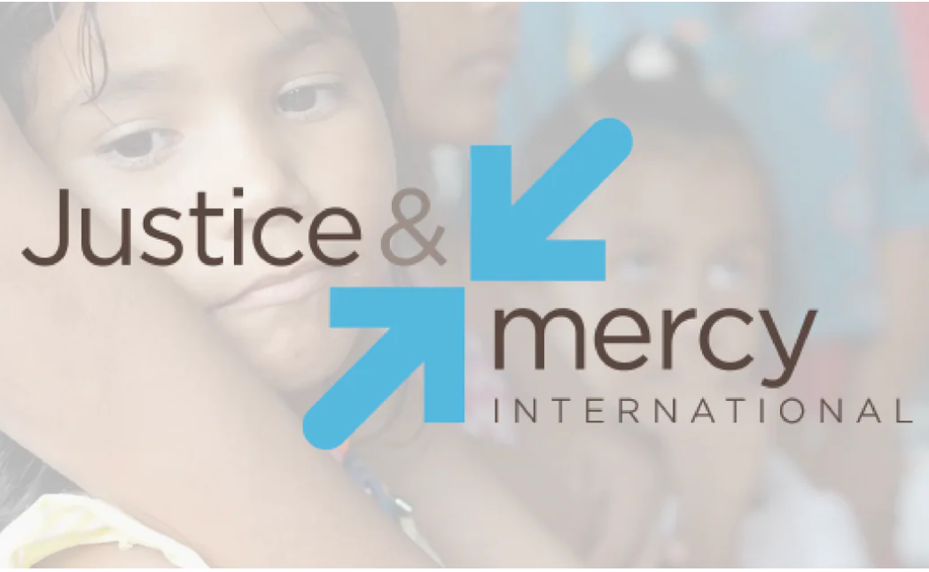 Justice and Mercy International logo, with whitewash photo of young girl in background. 